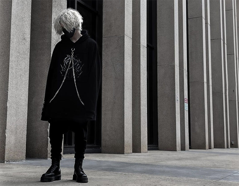 man wearing darkwear clothing in the street